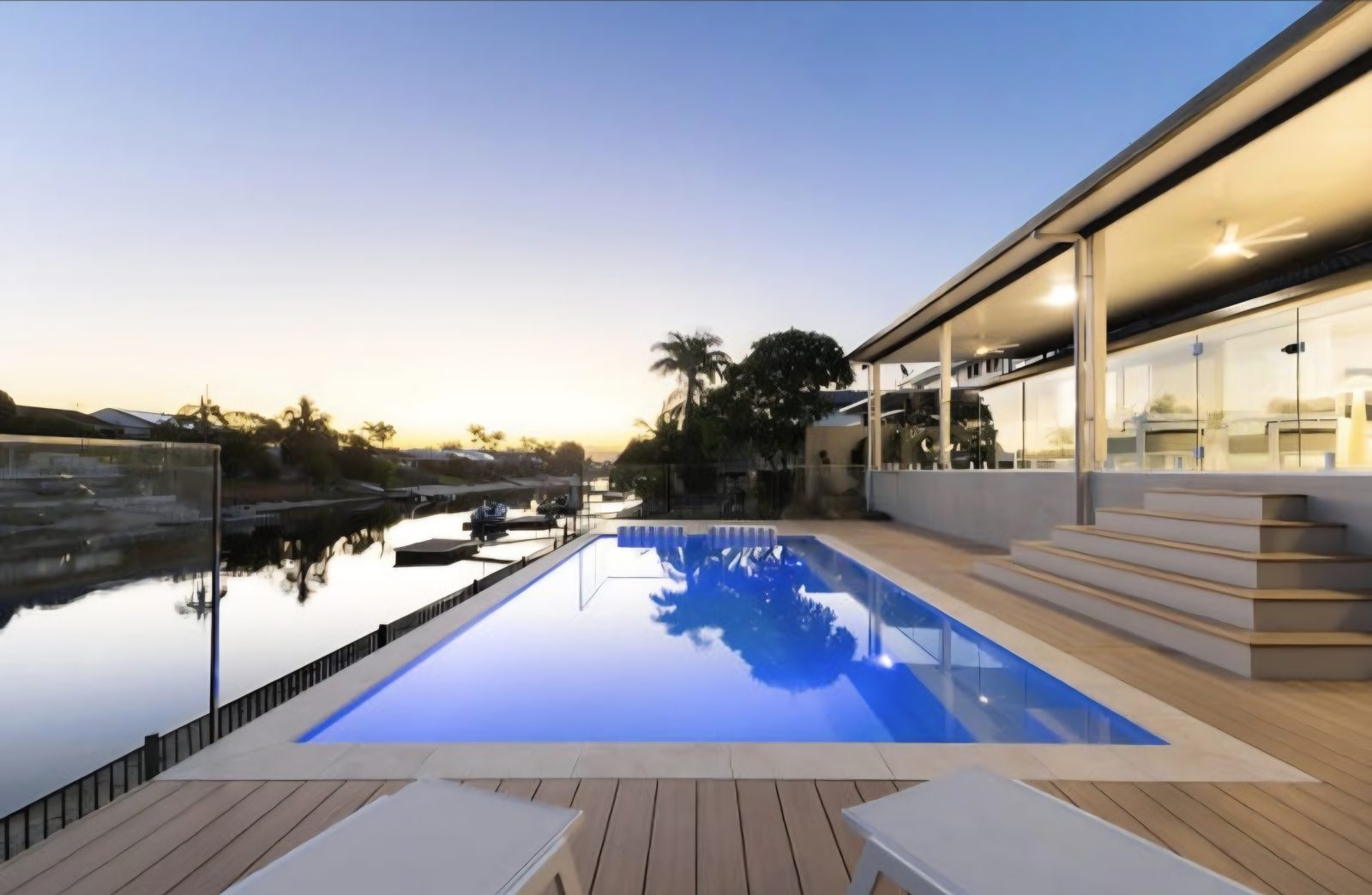 Canal-side deck and pool at dusk